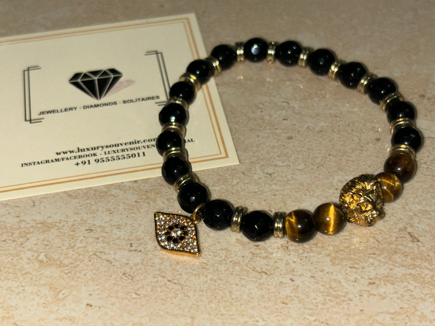 LionRoar Bracelet with Hanging Evil Eye Tag by LSO on black gold beads