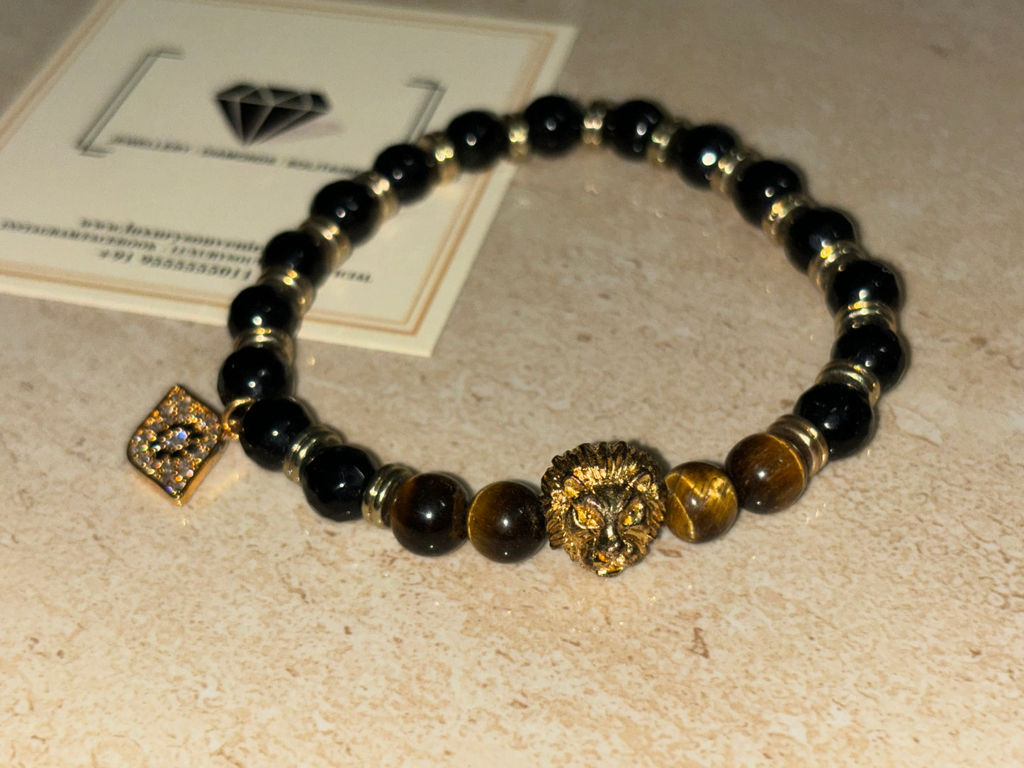 LionRoar Bracelet with Hanging Evil Eye Tag by LSO on black gold beads