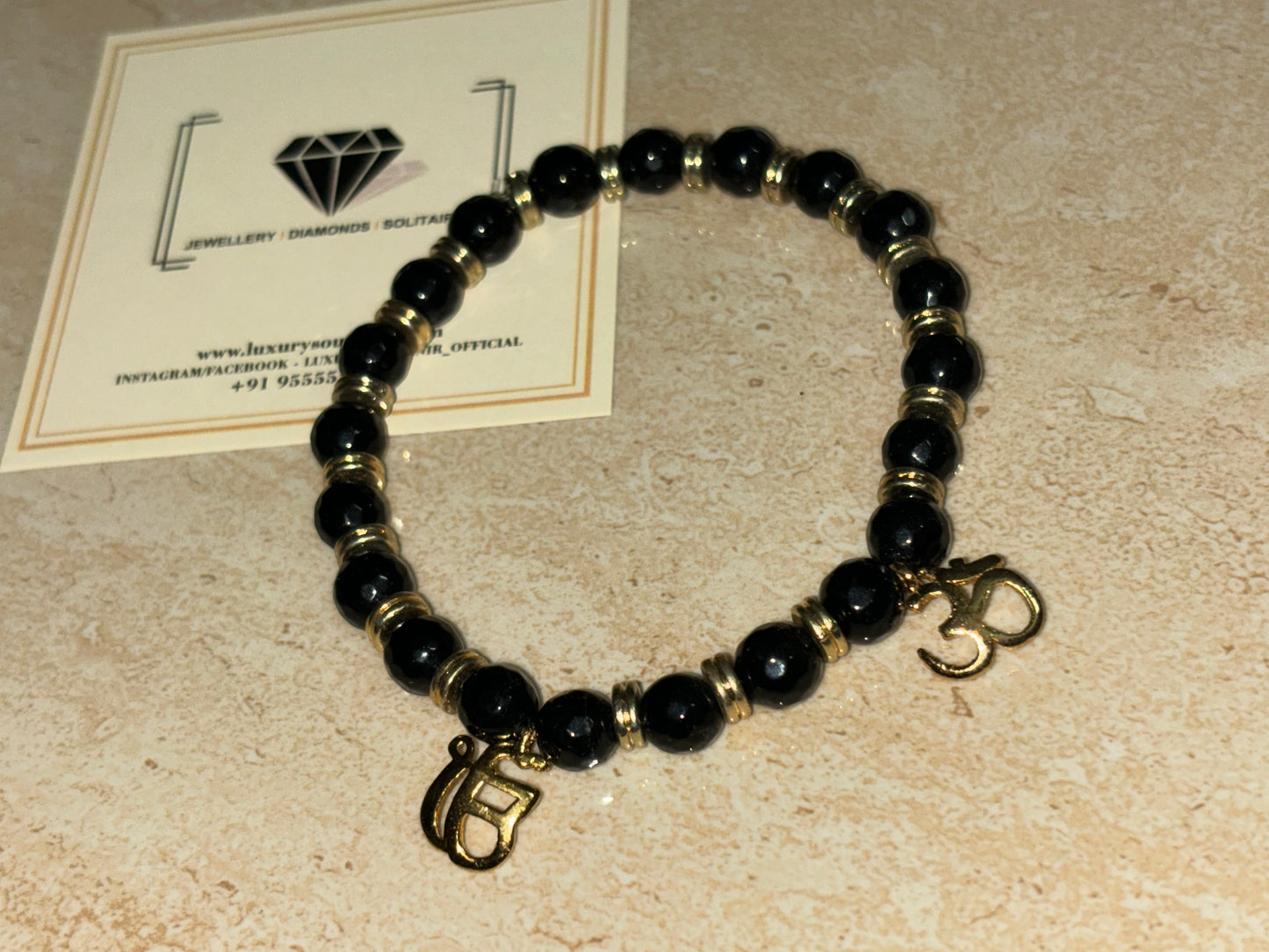 OM Ekonkar on black gold beads by LSO